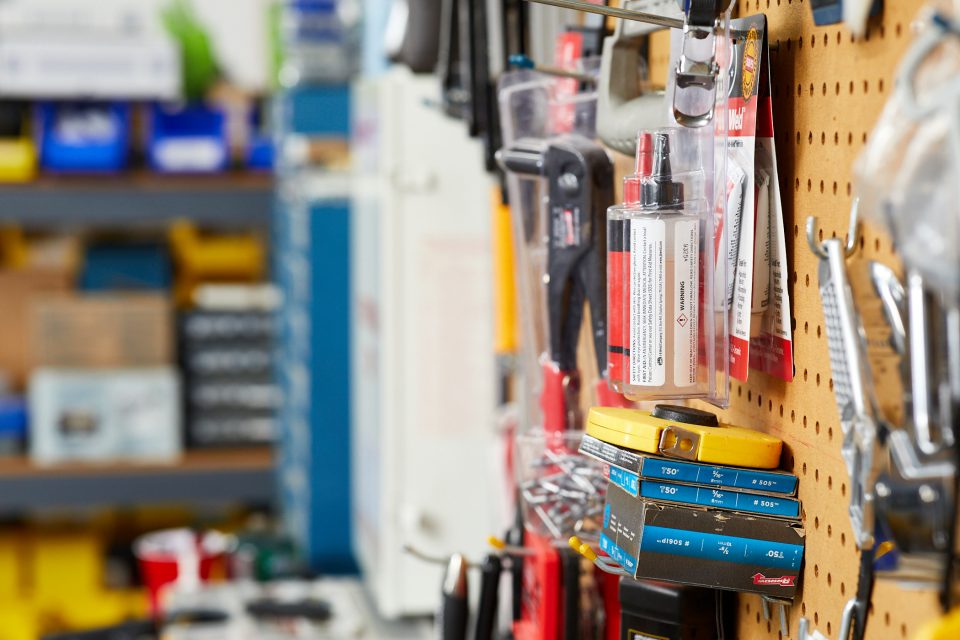 Tools and hardware hanging on a pegboard